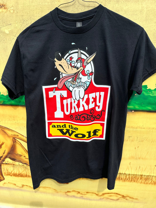 Photo of black shirt with a wolf dressed like pippi longstocking and red and yellow turkey and the wolf logo