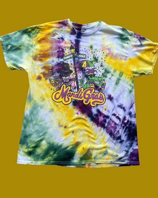 A colourful tie-dye Mardi Gras t-shirt with festive graphics on a yellow background