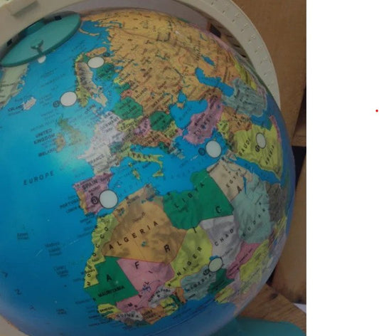 A close-up of a colorful globe with a focus on the continents of Europe and Africa.