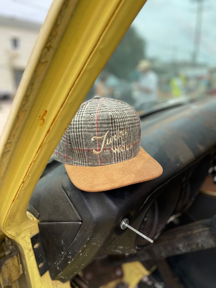 A hat resting on a car window.