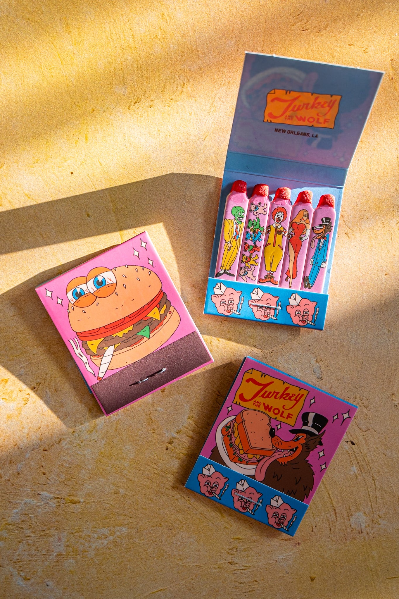 Colorful matchbox set with cartoon characters on a wooden surface