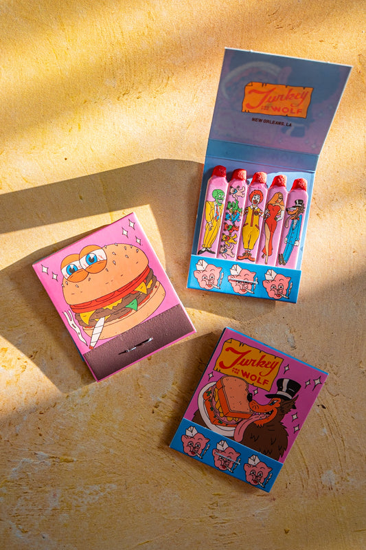 Colorful matchbox set with cartoon characters on a wooden surface