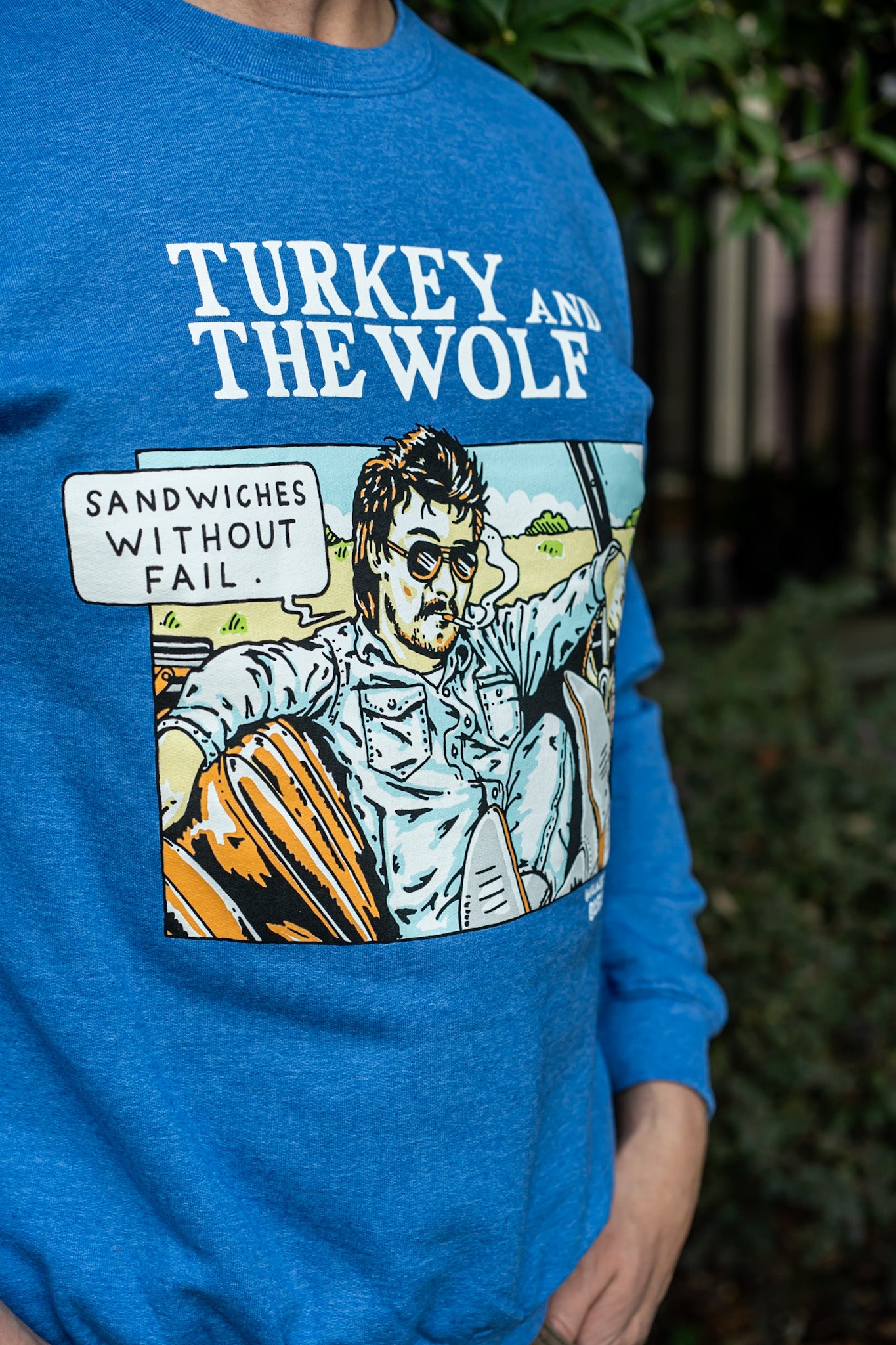 Blue t-shirt with 'Turkey and the Wolf' graphic and text