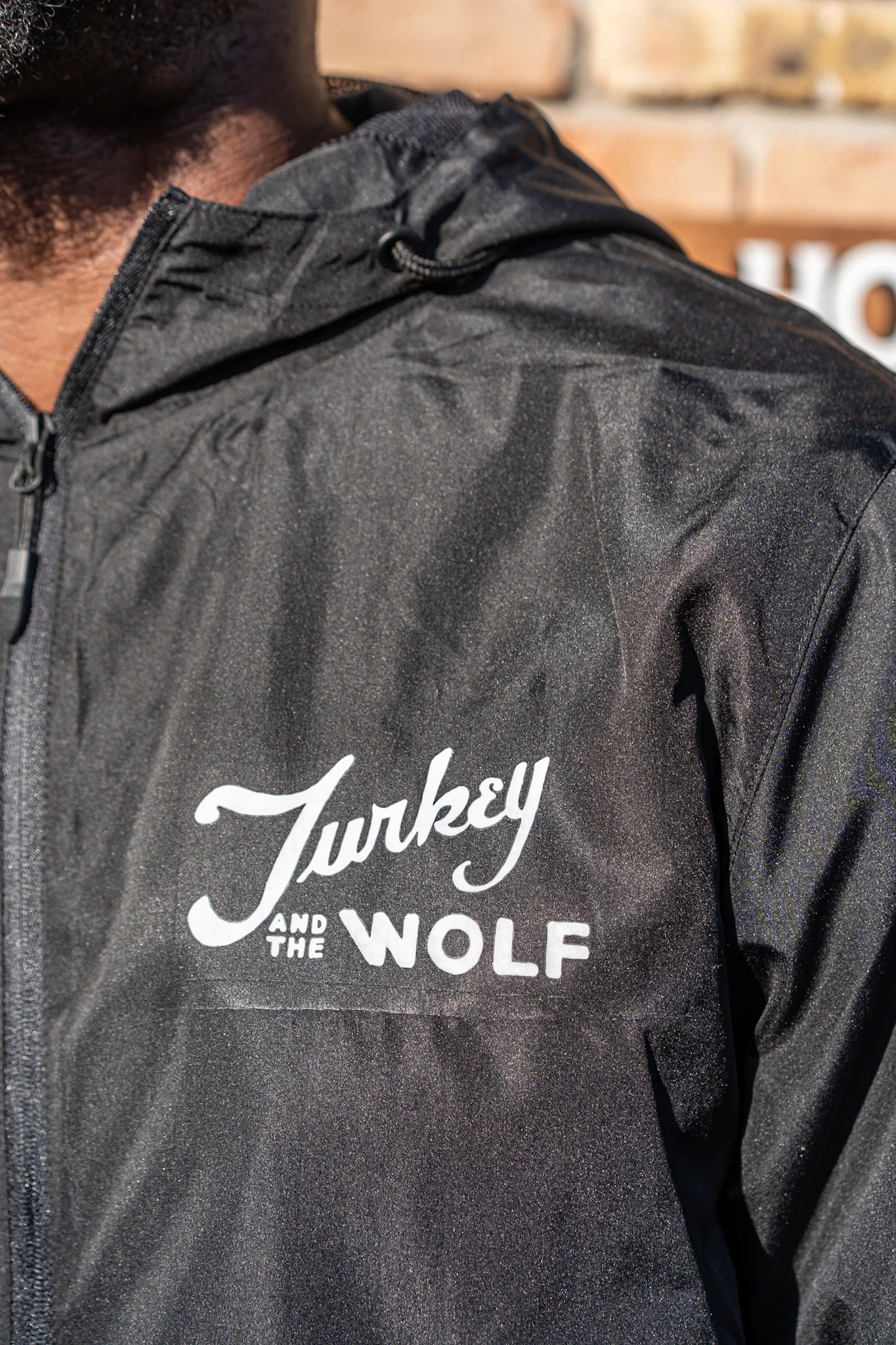 Black jacket with 'Turkey and the Wolf' logo on a person wearing it.