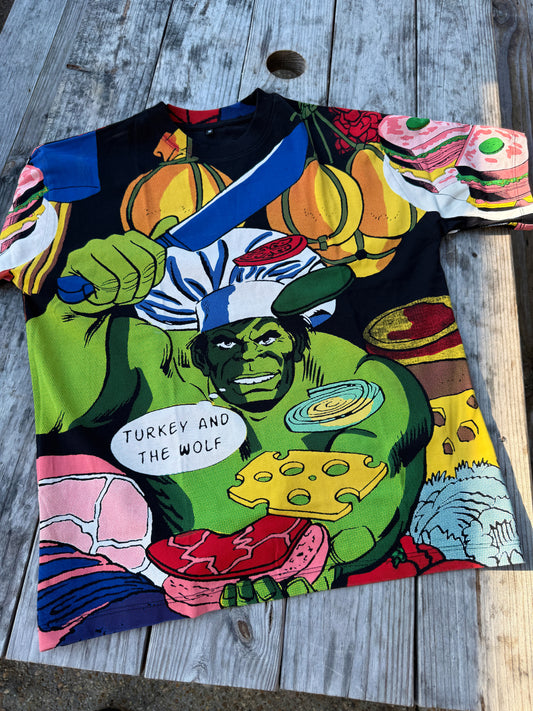 Colorful t-shirt with graphic design of a character holding a turkey and text on a wooden surface