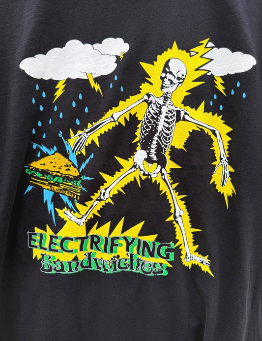 Black t-shirt with a skeleton holding a sandwich and lightning bolts, labeled 'Electrifying Sandwiches'.