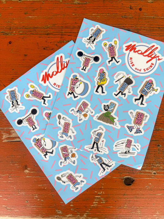Two sheets of stickers with cartoon characters and 'Molly' branding on a wooden surface.