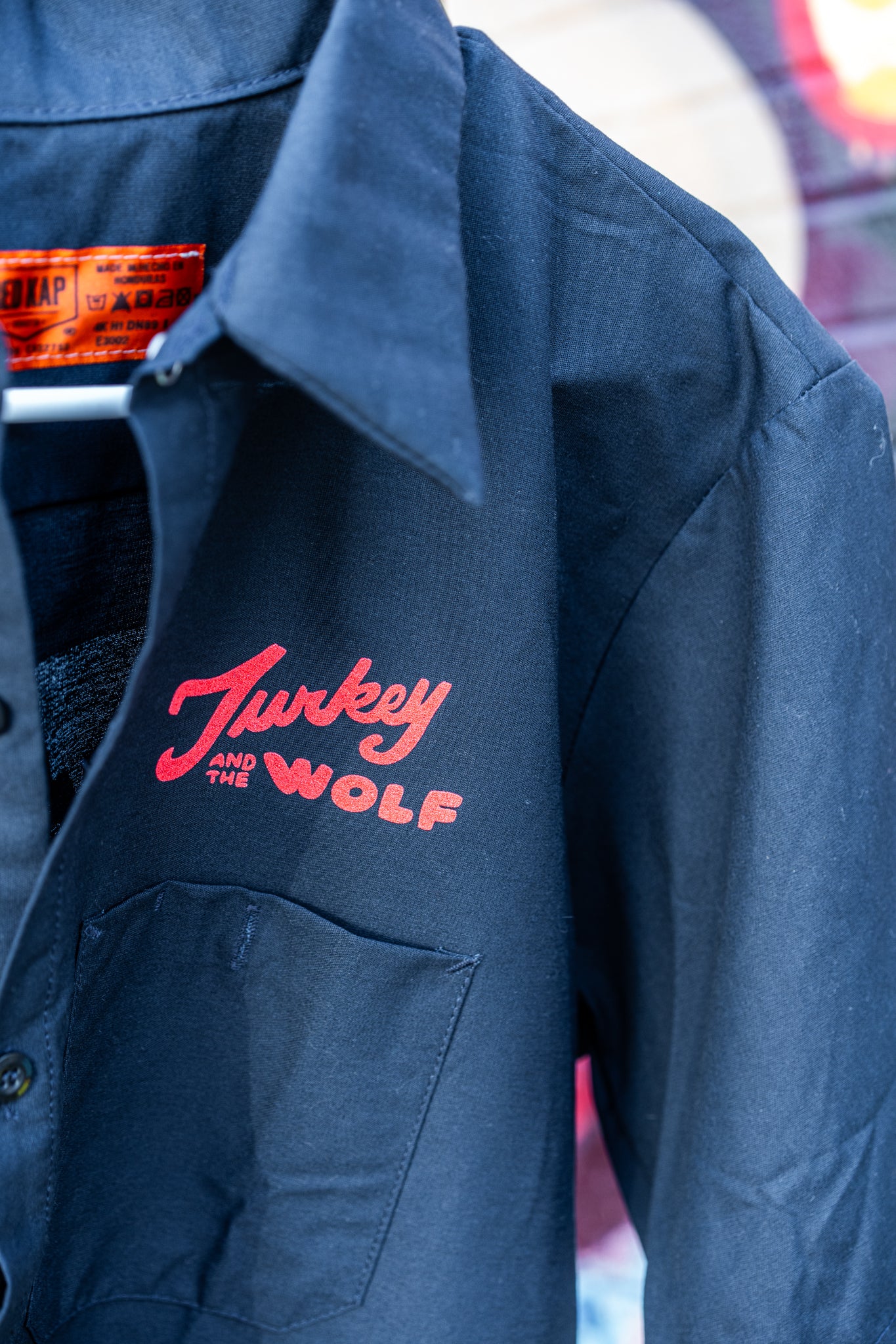 Black jacket with 'Turkey and the Wolf' logo on a blurred background